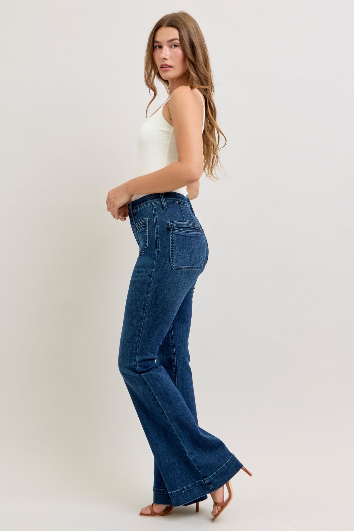 Judy Blue high waist pintuck flare jean in dark wash, back view with mitered pockets