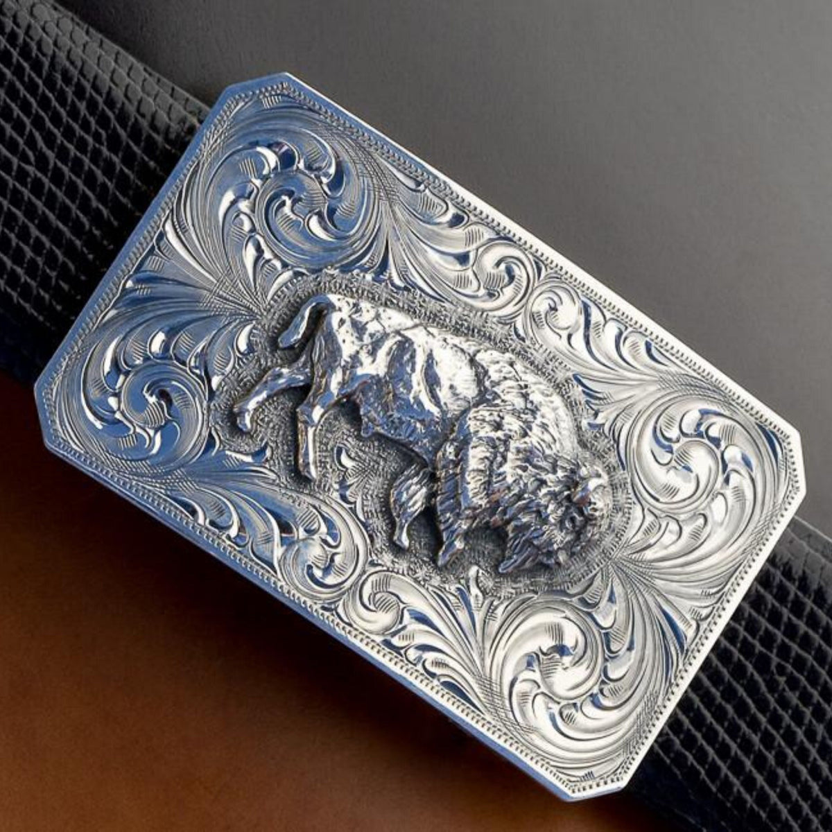 Detail of the Clint Orms Jasper 1800 sterling silver buffalo buckle and its hand-engraved scrollwork