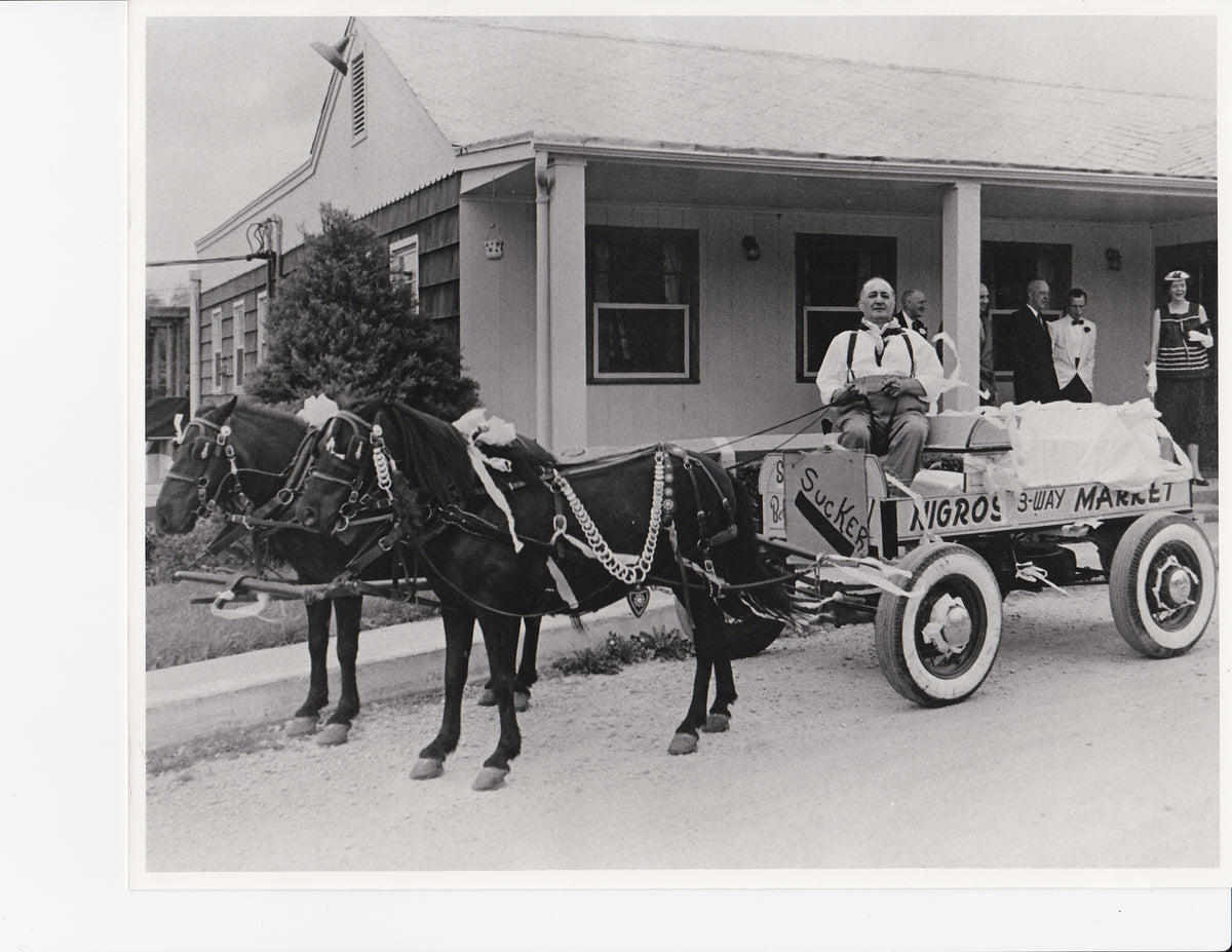Old black-and-white photo of a horse-drawn Nigro's wagon