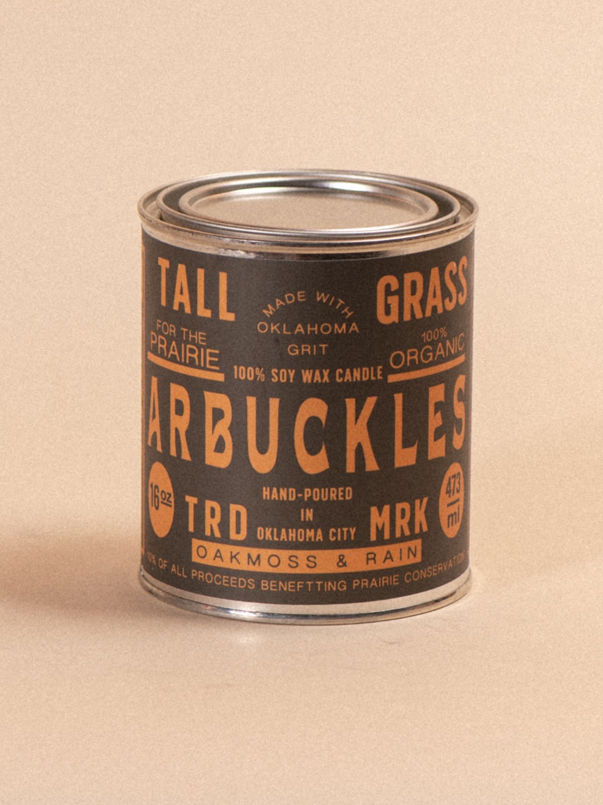 Tallgrass Supply Arbuckles soy wax candle with oakmoss and rain scent, featuring a tall, elegant candle design.