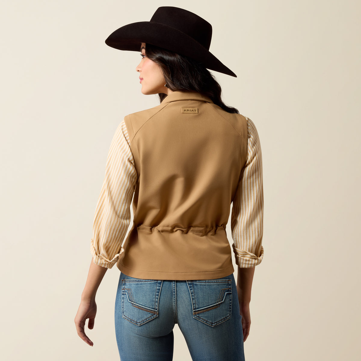 Ariat Women's Atlas Vest in Tiger's Eye color, featuring a lightweight, sleeveless design with front pockets and adjustable straps.