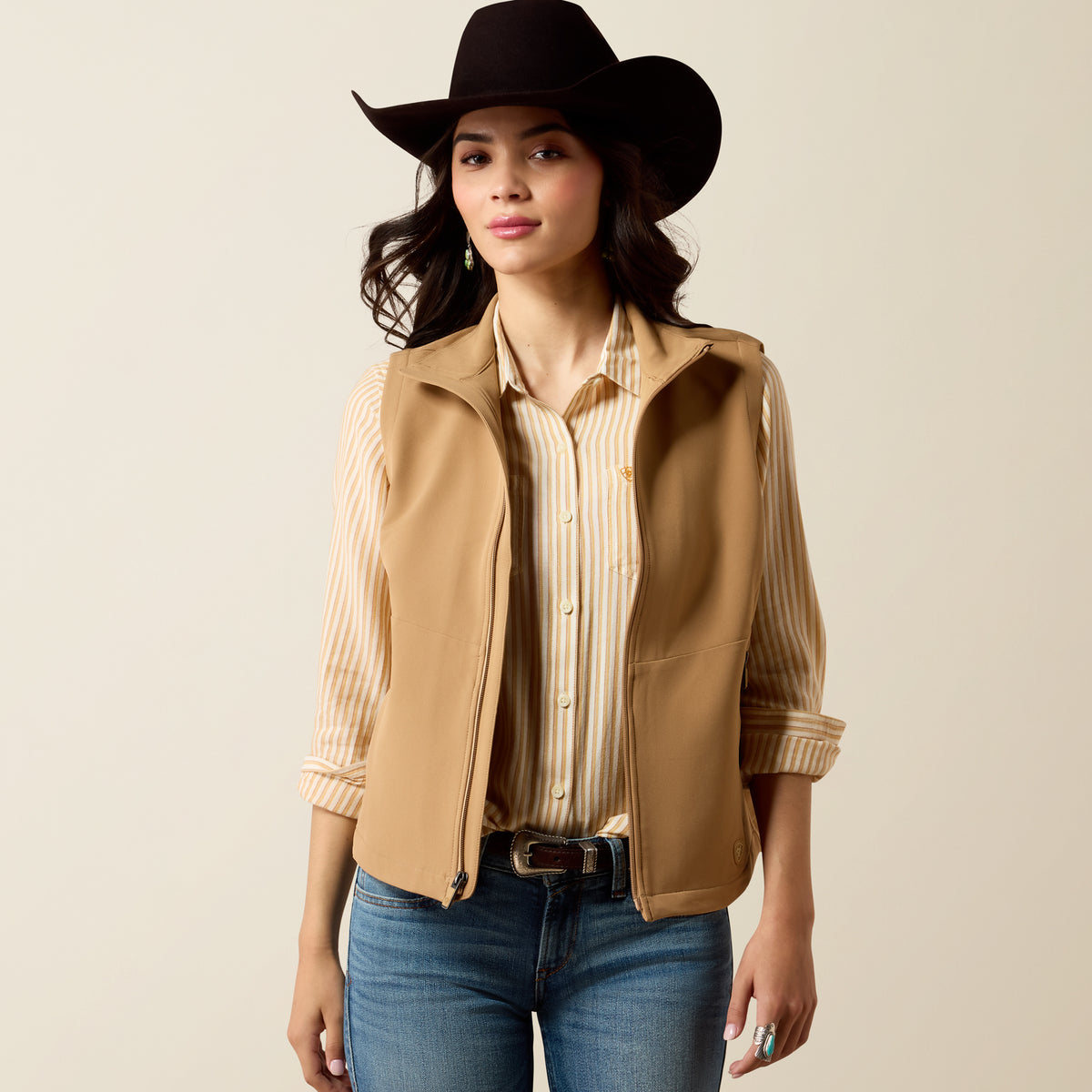 Ariat Women's Atlas Vest in Tiger's Eye color, showing a stylish, fitted vest with a front zipper and subtle branding detail.