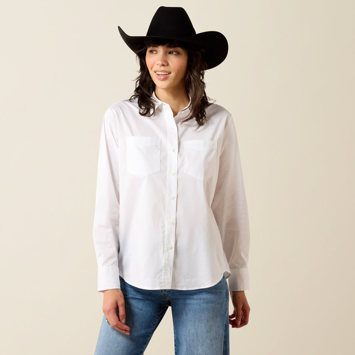 Ariat women's long sleeve white shirt with a relaxed fit and button front, perfect for casual or outdoor wear.