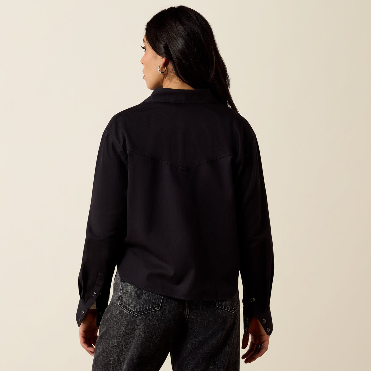 Ariat Women's Midnight Western Snap Shirt in black, featuring snap buttons and Western-style design, displayed on a model.