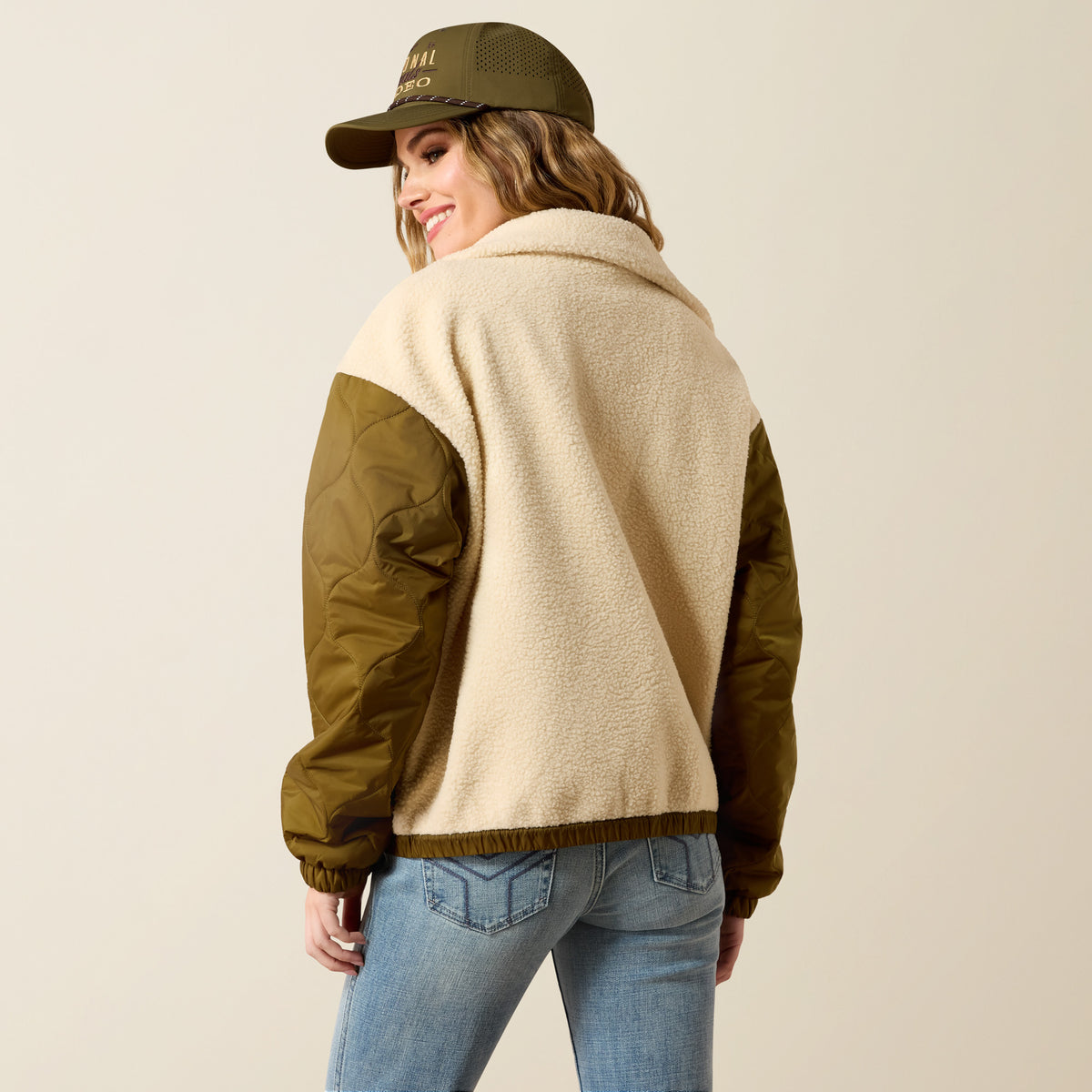 Ariat Women's Sherpa Blocked Jacket in Parchmen and Moss Green, showing the cozy fleece-lined design and color blocking style.
