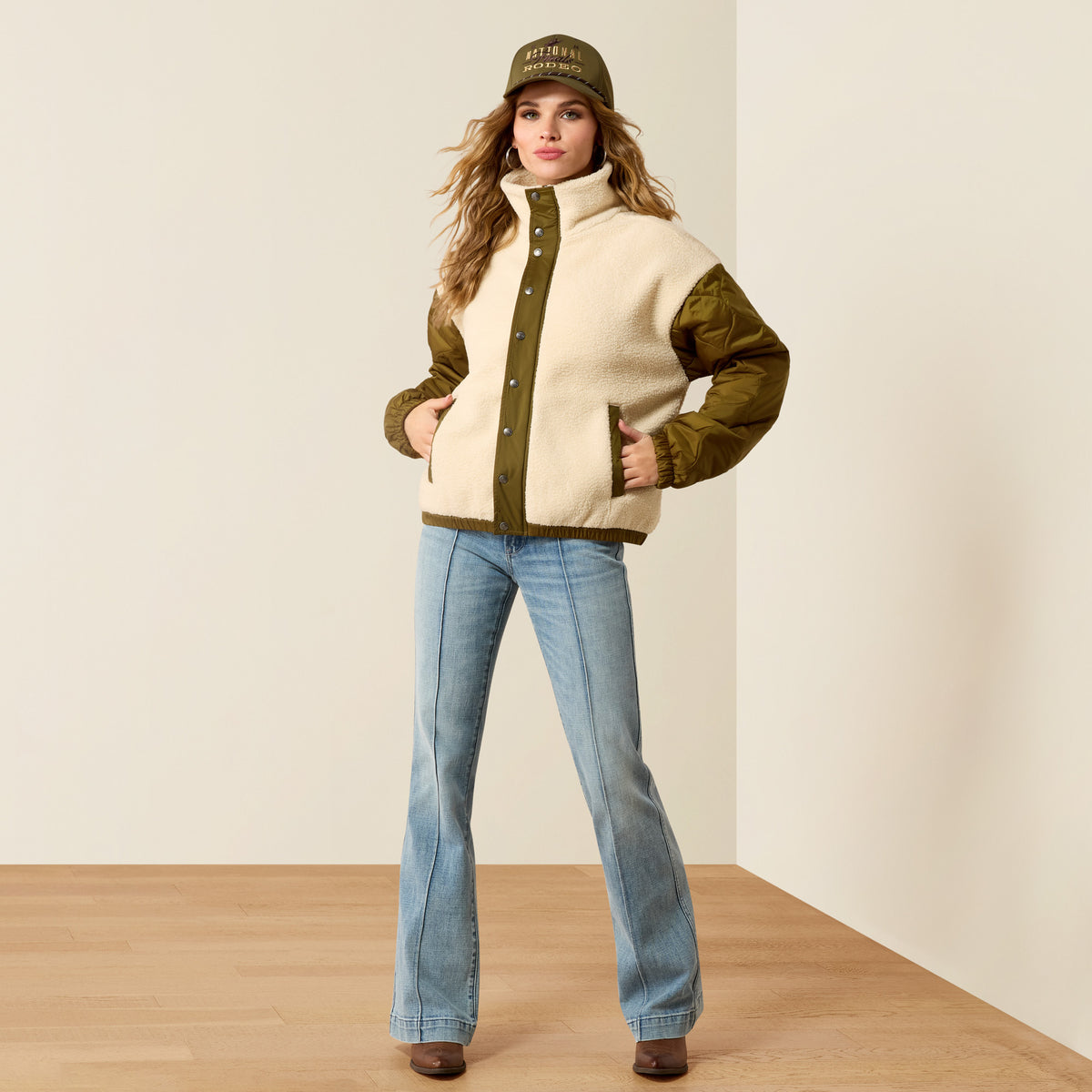 Ariat Women's Sherpa Blocked Jacket in Parchmen and Moss Green, showing the cozy fleece-lined winter jacket with color blocking.