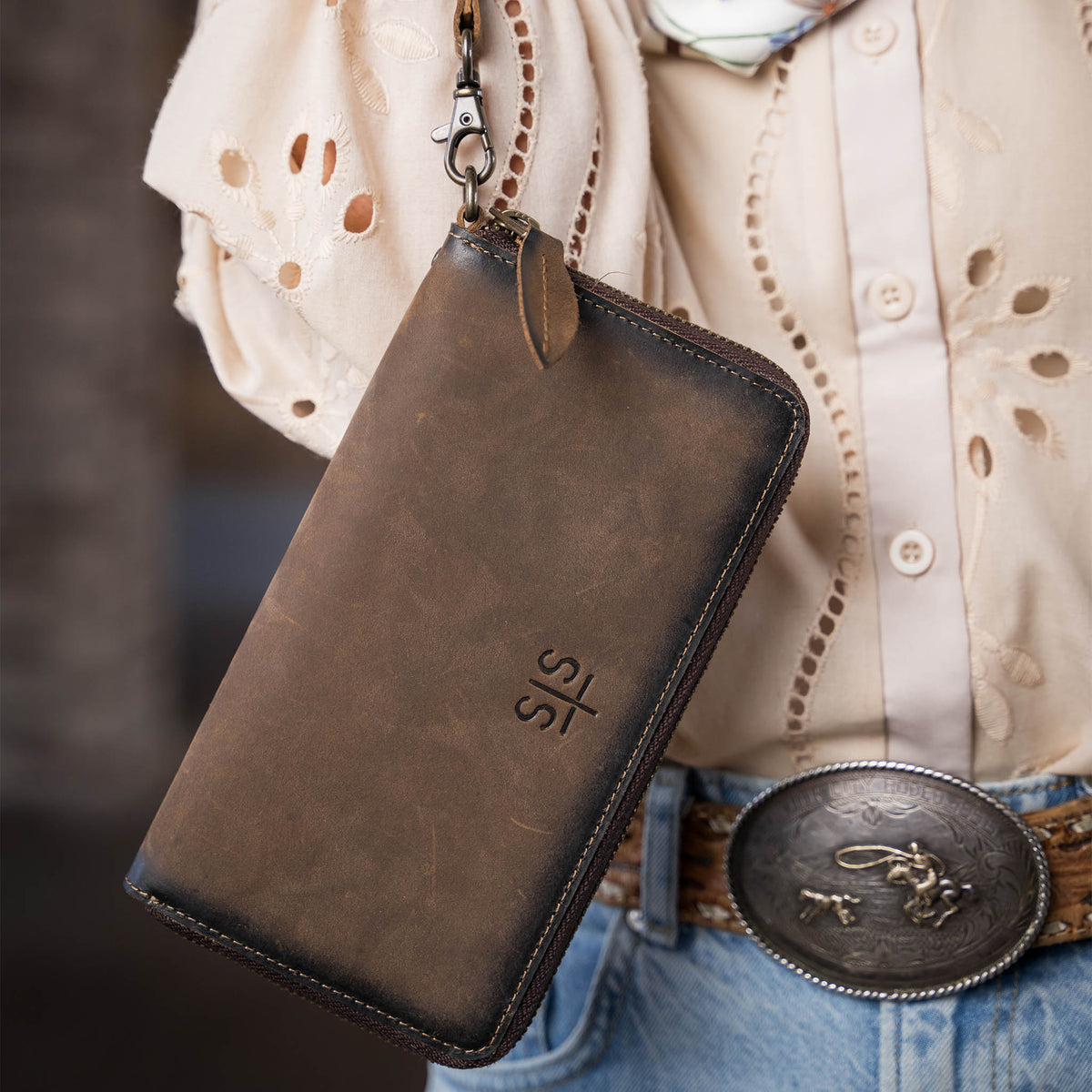 STS Ranchwear Baroness Betsy Bifold Wristlet showing leather exterior with wrist strap and classic Western style.
