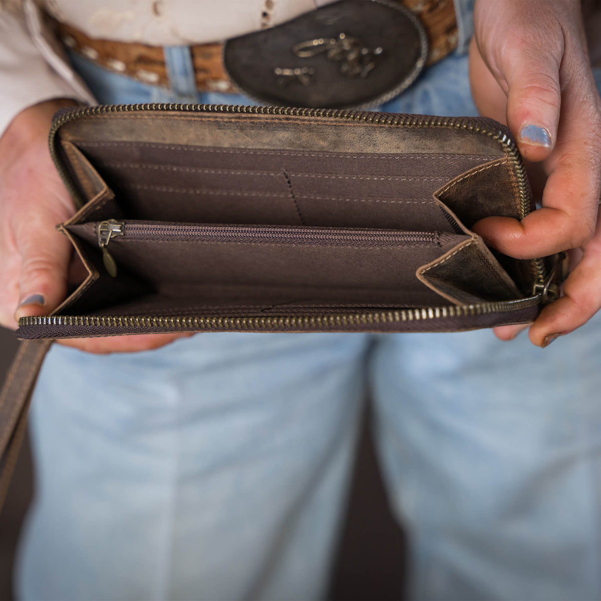 STS Ranchwear Baroness Betsy Bifold Wristlet featuring leather material and a compact design with a wrist strap.