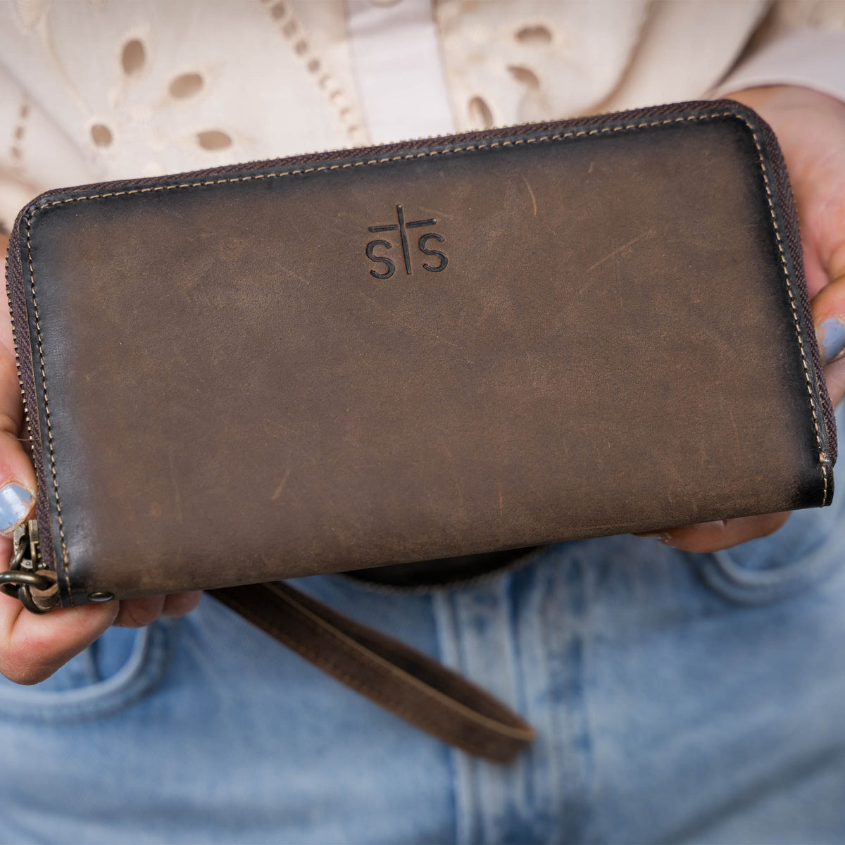 STS Ranchwear Baroness Betsy Bifold Wristlet featuring leather design with a zip closure and wrist strap for easy carrying.