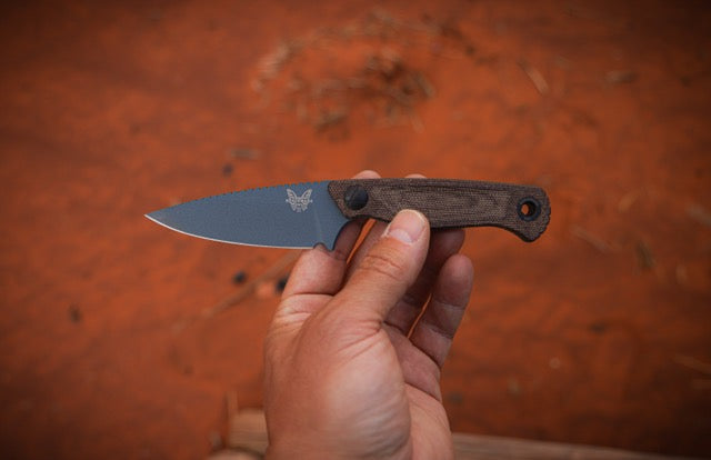 Benchmade Dacian knife with brown canvas Micarta handle and spear-point blade, showcasing a sleek and durable design.