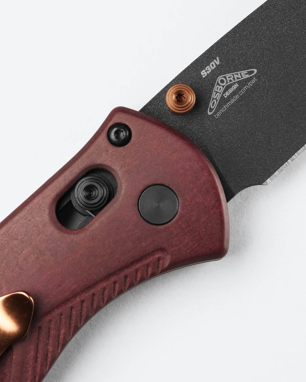 Benchmade Mini Barrage knife with redstone handle and drop-point blade, showcasing its compact, versatile design.
