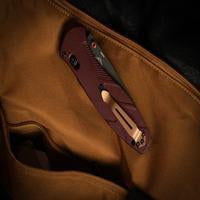 Benchmade Mini Barrage drop-point knife with redstone handle, compact folding knife with stainless steel blade.