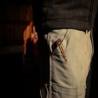 Benchmade Mini Barrage knife with redstone handle and drop-point blade, showcasing a compact, tactical folding knife design.