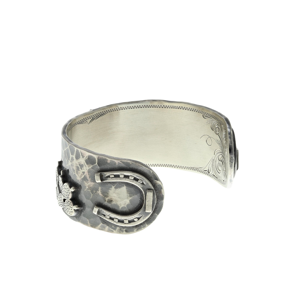 Side view of the Clint Orms 1432 sterling silver cuff bracelet showing the horseshoe and engraved edge