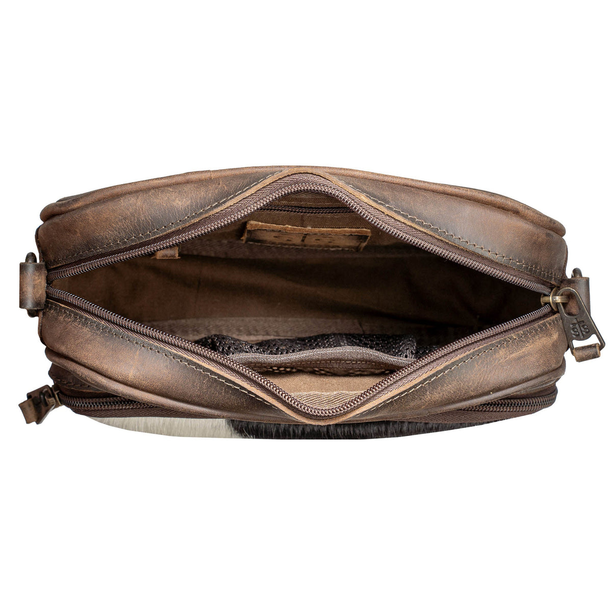 STS Ranchwear Cowhide Jess Crossbody bag featuring a stylish cowhide pattern and leather accents.