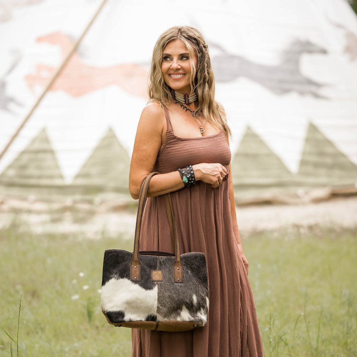 Cowhide Josie Tote by STS Ranchwear featuring a stylish, durable leather and cowhide design with sturdy handles and spacious interior.