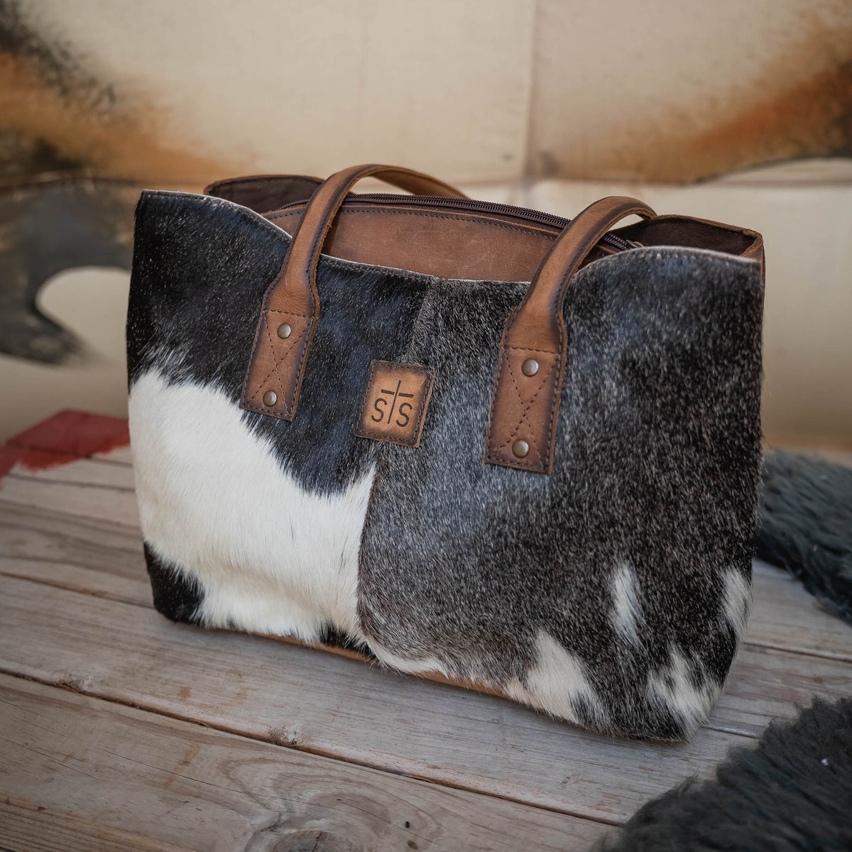 Cowhide Josie Tote by STS Ranchwear featuring a stylish, durable handbag with natural cowhide pattern and leather accents.