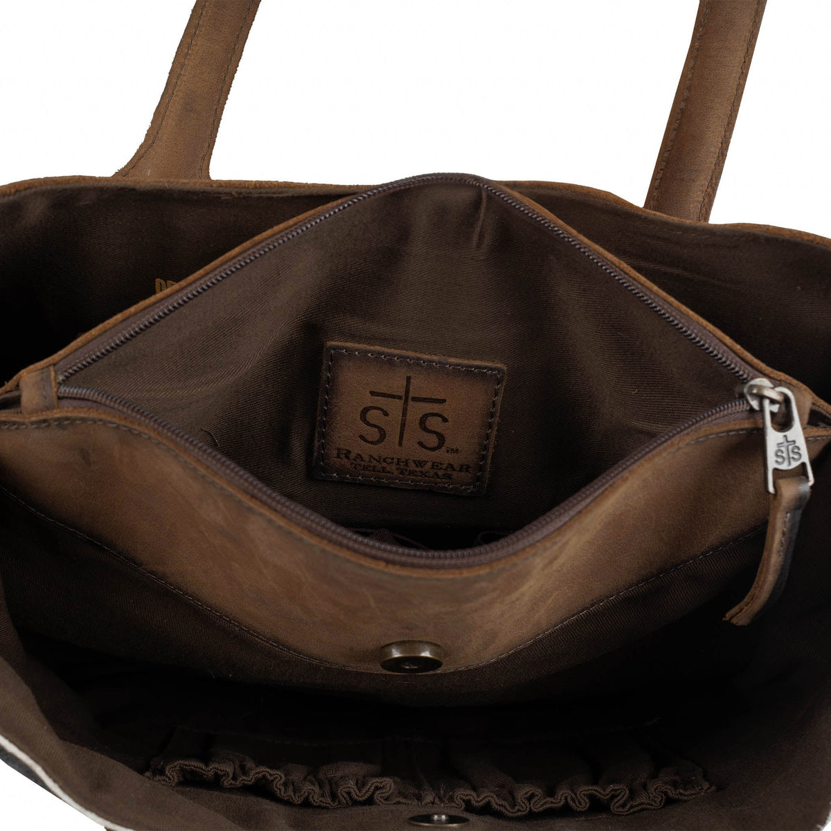 Cowhide Josie Tote handbag by STS Ranchwear, showing natural cowhide pattern, sturdy leather straps, and spacious interior.