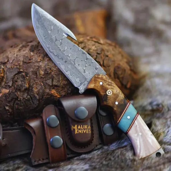 Malika Knives Damascus Gut Hook Hunting Knife with wood resin handle, showcasing a simple, durable design for outdoor hunting tasks.