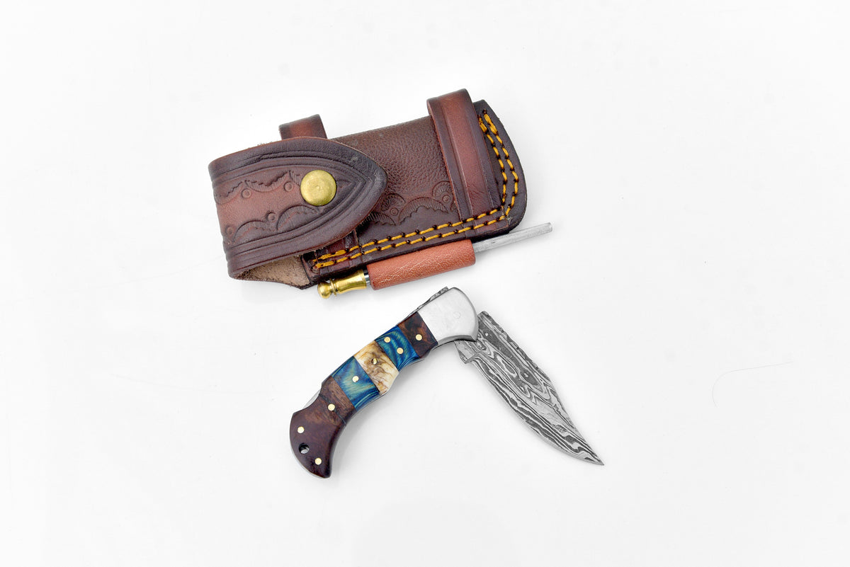 Damascus steel pocket knife by Titan International K with a patterned blade and ergonomic handle, limited run TF-071.
