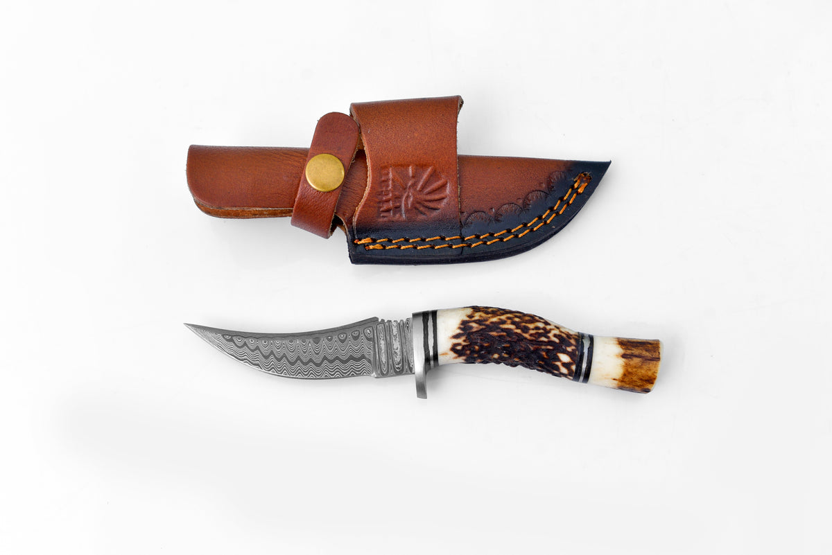 Deer Horn Trailblazer Damascus hunting and survival knife by Titan International K, featuring a Damascus steel blade and deer horn handle.