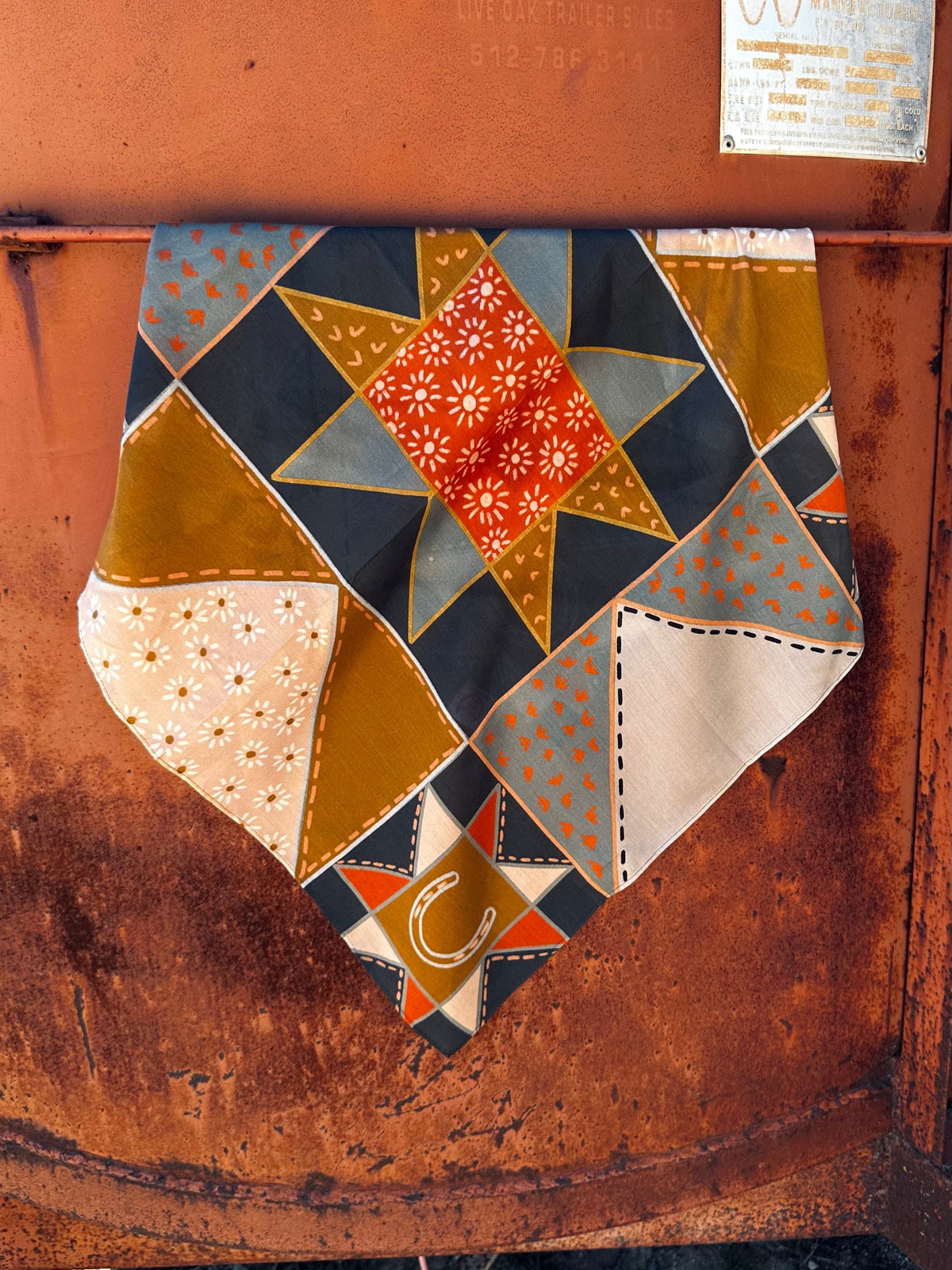 Tirzah Lane Art Frontier Bound Patchwork Rust Western Silk Wild Rag Scarf displayed with intricate patchwork and vibrant rust tones.