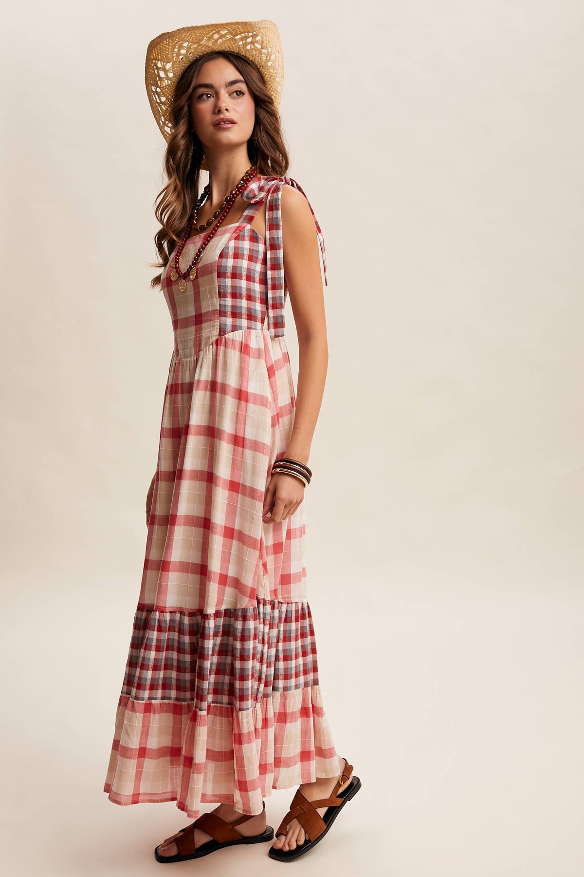 Gingham tiered maxi dress by Listicle featuring a flowy, layered design and sleeveless style in a classic checkered pattern.