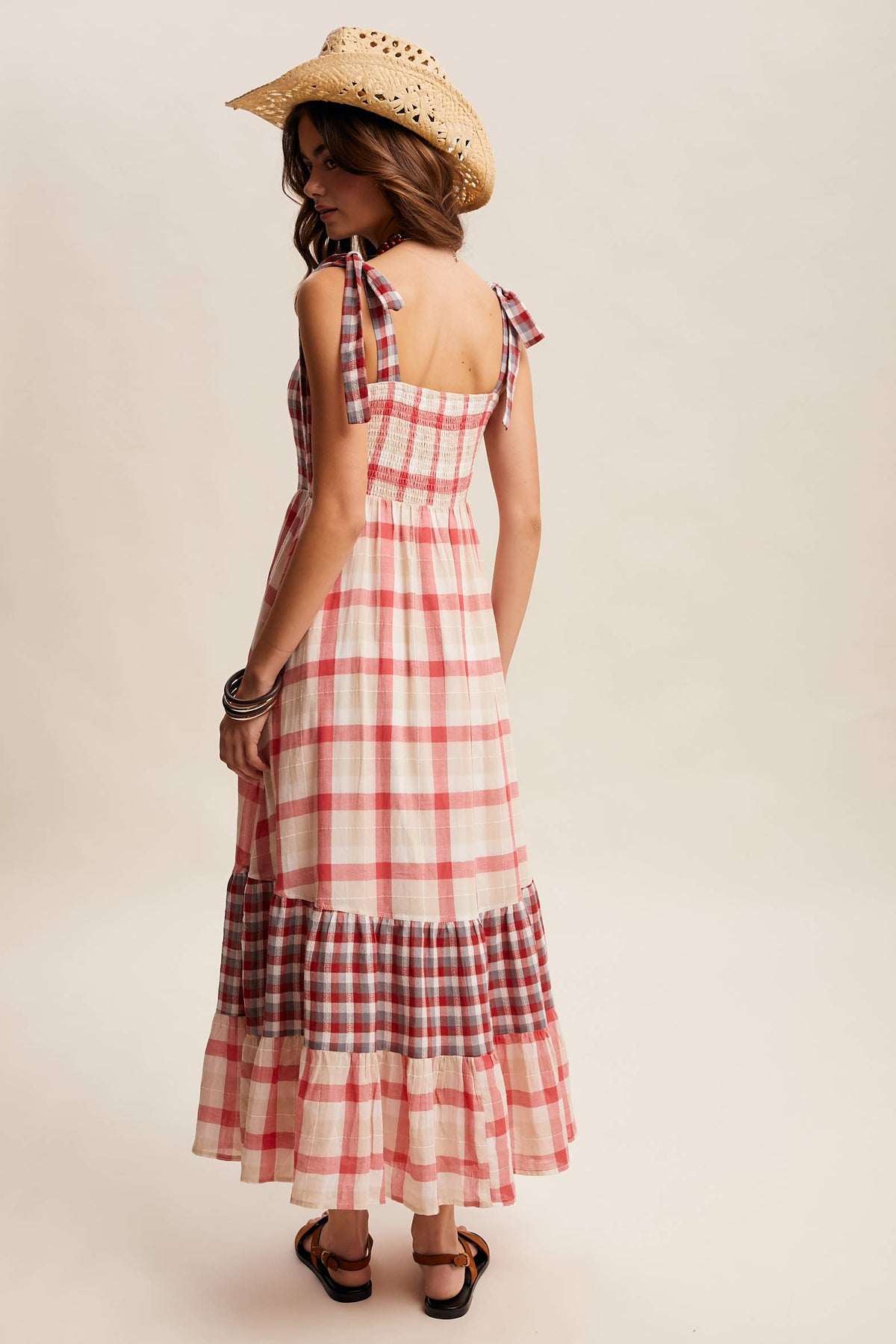 Gingham tiered maxi dress by Listicle featuring a flowy silhouette and tiered design in classic black and white gingham pattern.