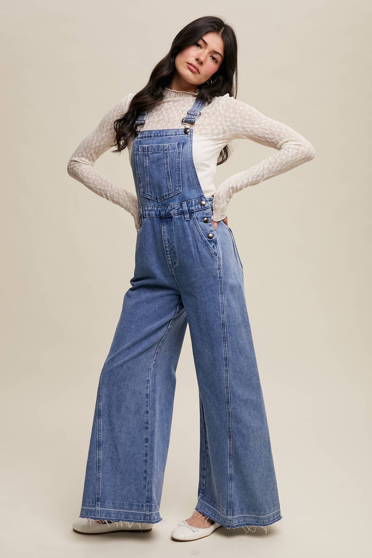 Wide-leg denim overalls from Listicle featuring adjustable straps, front pocket, and relaxed fit, displayed on a neutral background.