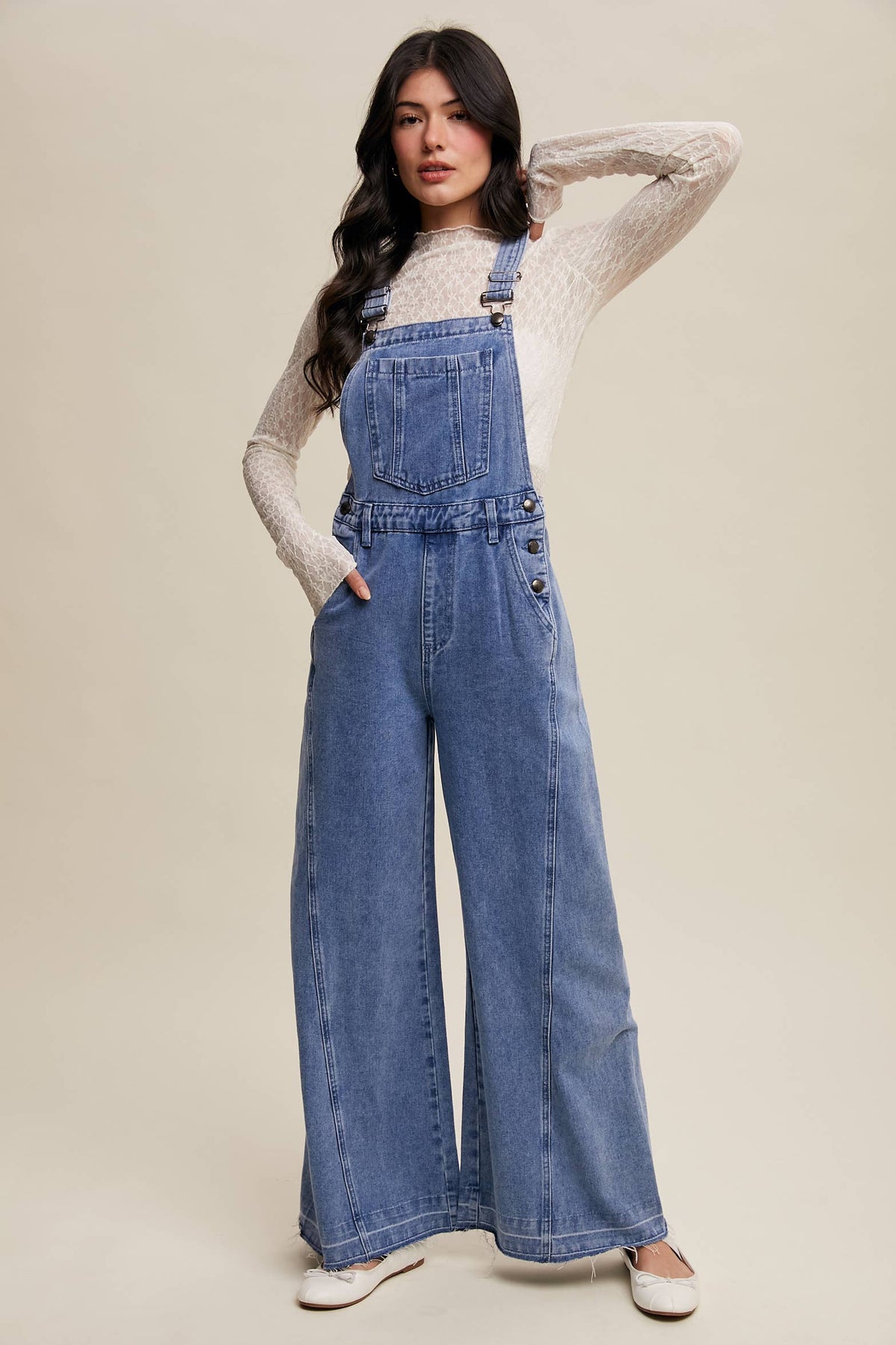 Wide-leg denim overalls by Listicle featuring a relaxed fit, classic blue wash, and adjustable straps, styled for casual wear.