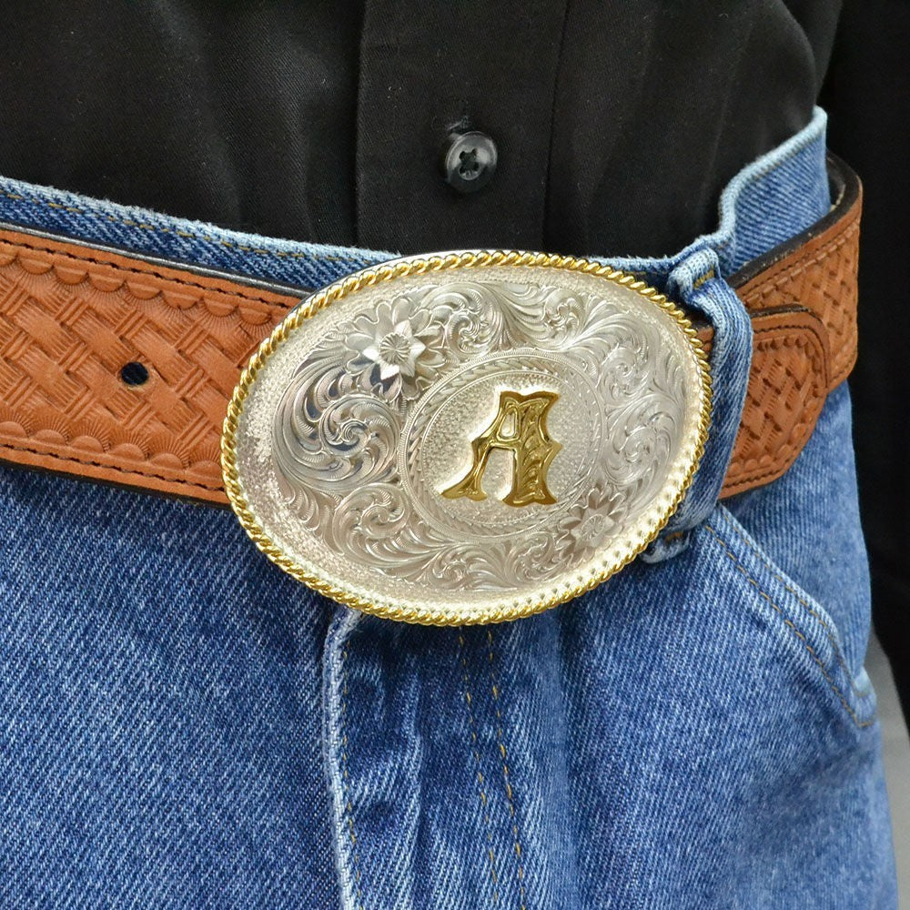 Montana Silversmiths initial silver engraved western belt buckle with gold trim, featuring detailed Western-style design.