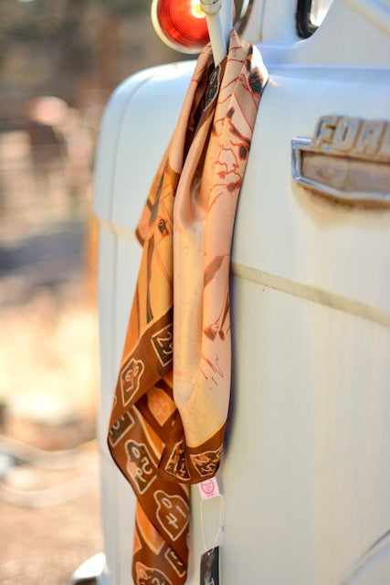 Tirzah Lane Art floral cowgirl bandana made of 100% Mulberry silk, 35x35 inches, with western-inspired cattle design.