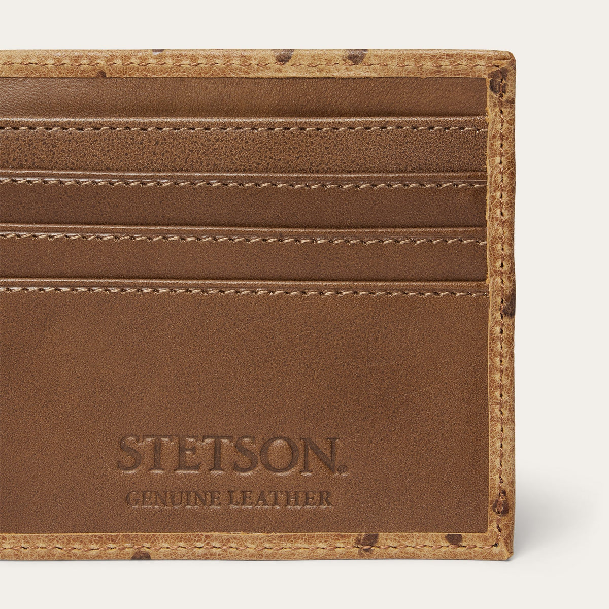 Stetson tooled embossed ostrich leather bi-fold wallet by Gem Dandy, featuring detailed tooling and textured ostrich pattern.