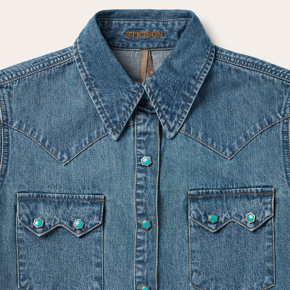 Stetson turquoise snap western denim shirt with button closure and classic Western design, displayed on a hanger.