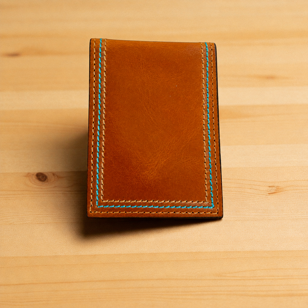Reverse of the Twisted X leather money clip card holder with a turquoise stitched edge