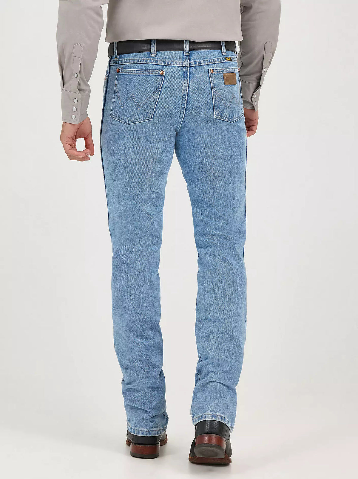 Wrangler Men's Cowboy Cut Slim Fit Jeans in antique wash with classic five-pocket design and rugged denim fabric.