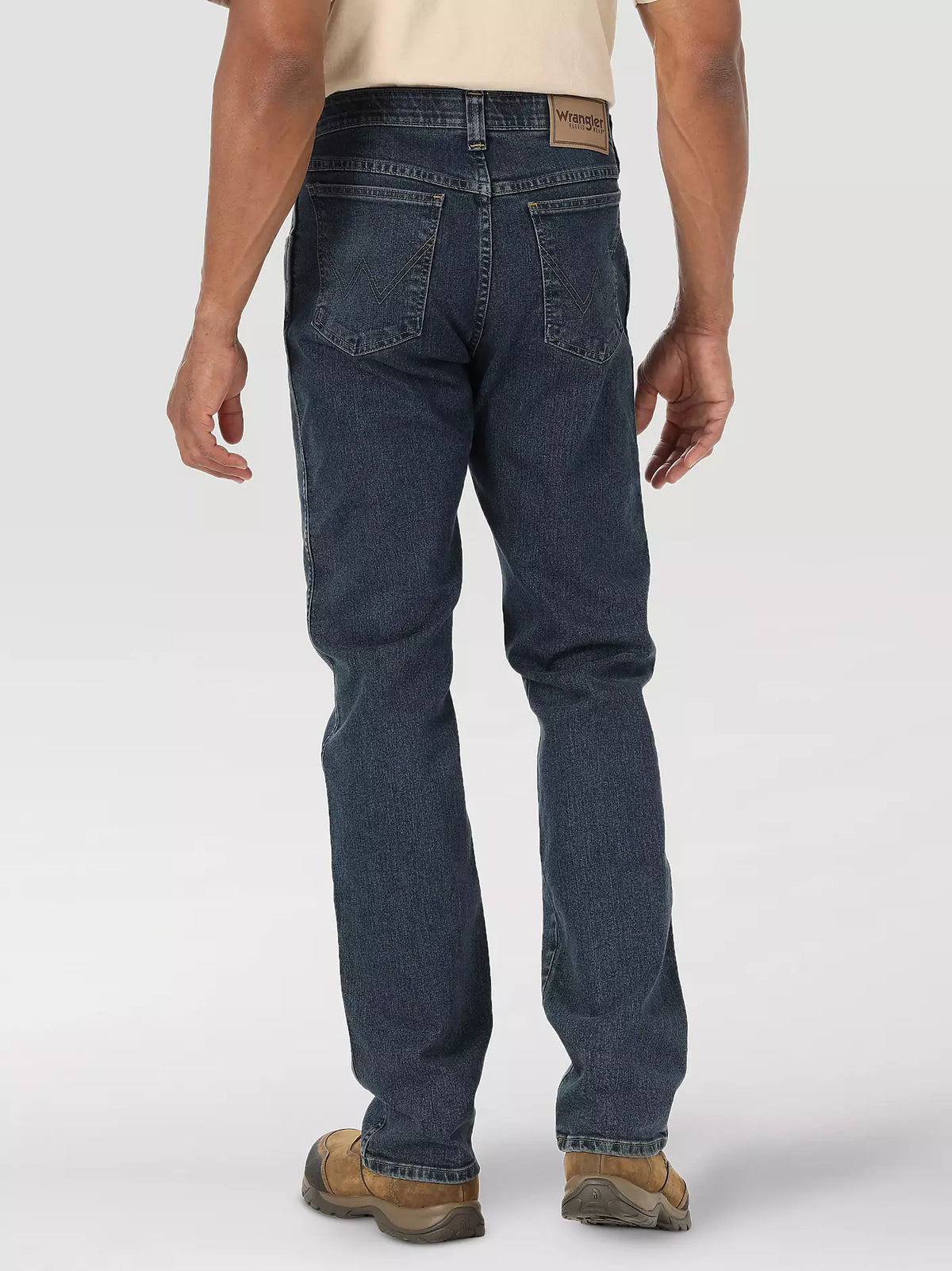 Wrangler Men's Rugged Wear Performance Series Regular Fit Jeans in mid-indigo denim, showcasing classic five-pocket style and durable fabric.