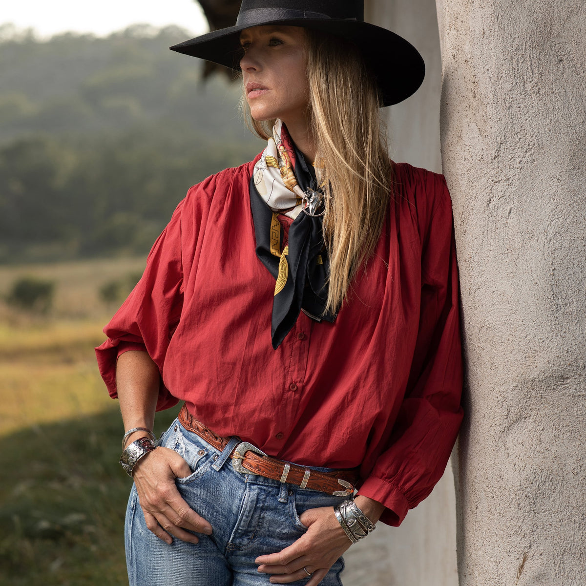 Woman in a red western shirt and black felt hat wearing the Clint Orms 1432 sterling silver cuff bracelet