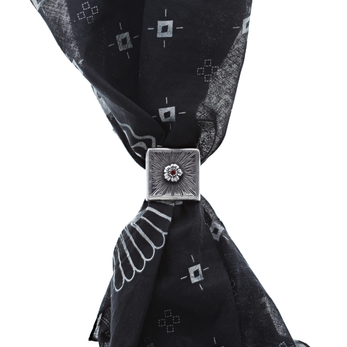Clint Orms 1835 sterling silver concho scarf slide worn on a black patterned wild rag