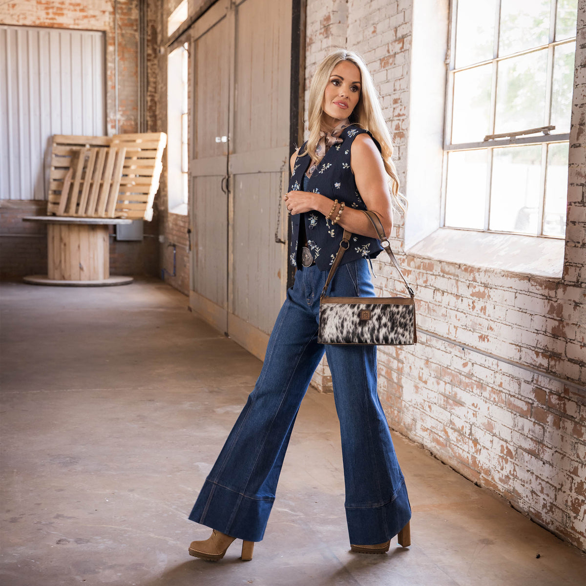 STS Ranchwear Women's Cowhide Bailey Bag, Black and White Hair-On – lifestyle on model, walking