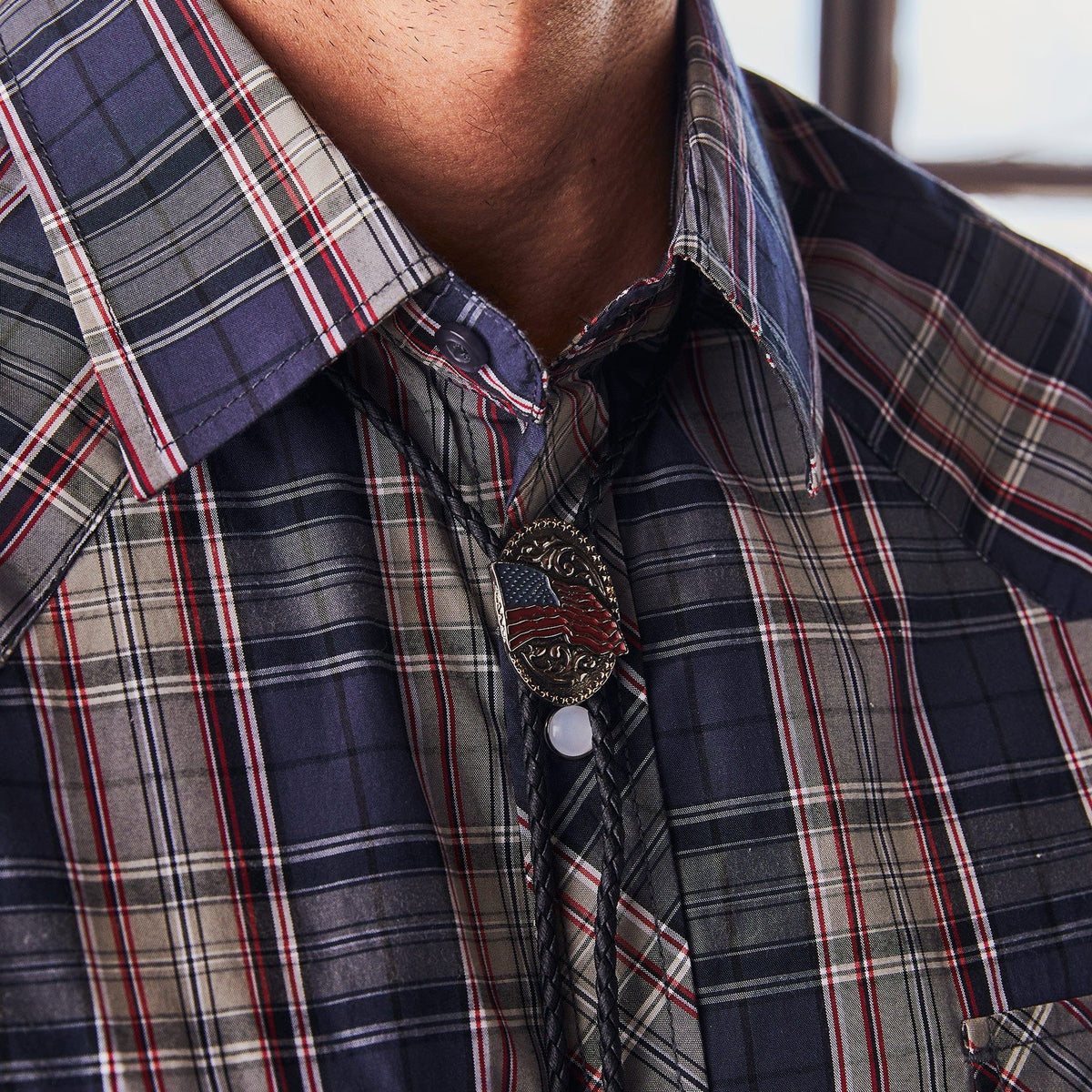 AndWest American Flag bolo tie featuring a patriotic design with a metal slide and cord for western or casual wear.