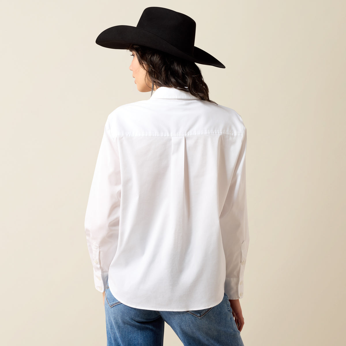 Ariat women's long sleeve white shirt with a relaxed fit, featuring a classic collar and button-up front, suitable for casual or workwear.
