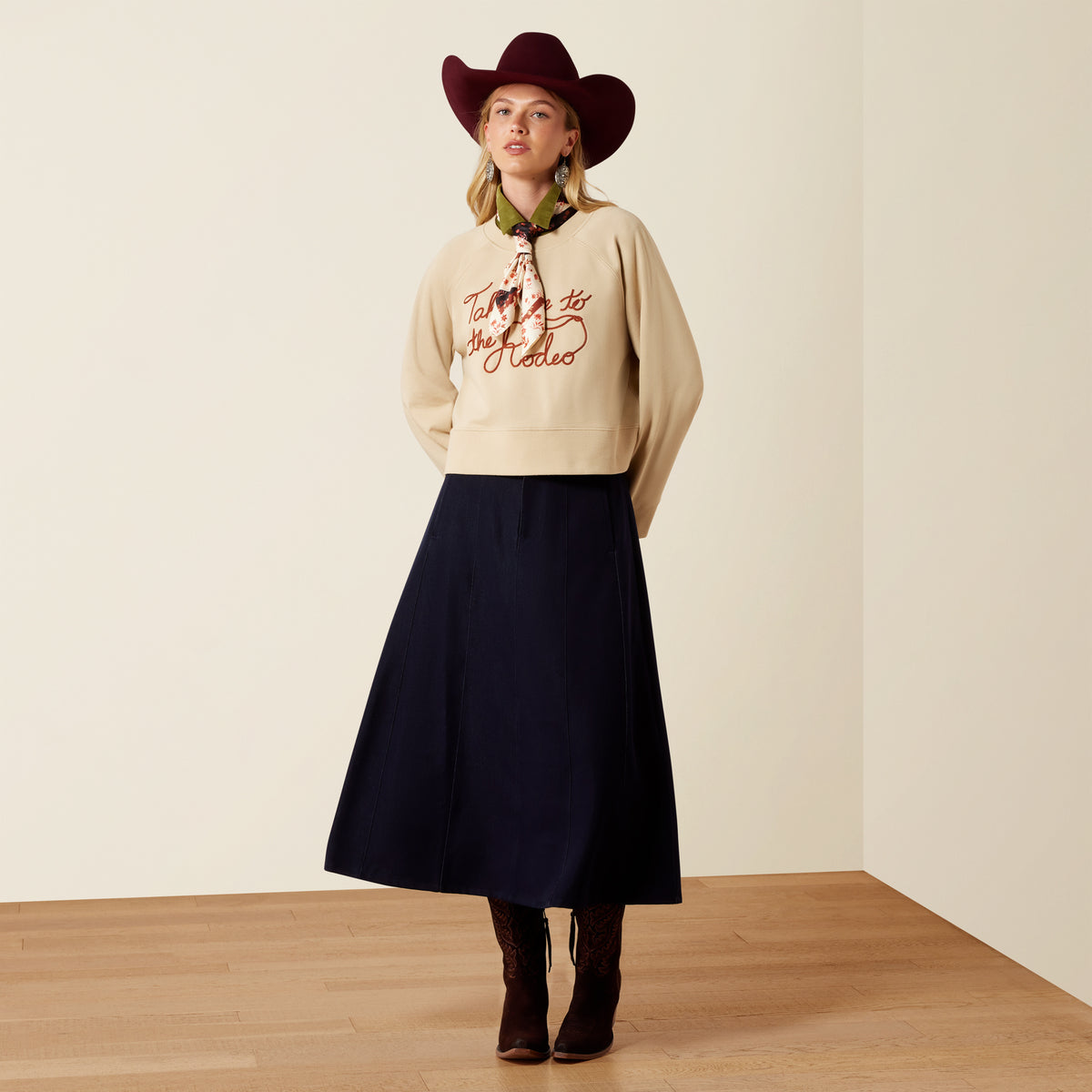 Ariat Women's Sydney Sweatshirt in Irish Cream, soft knit fabric, long sleeves, and casual fit, displayed on a hanger.