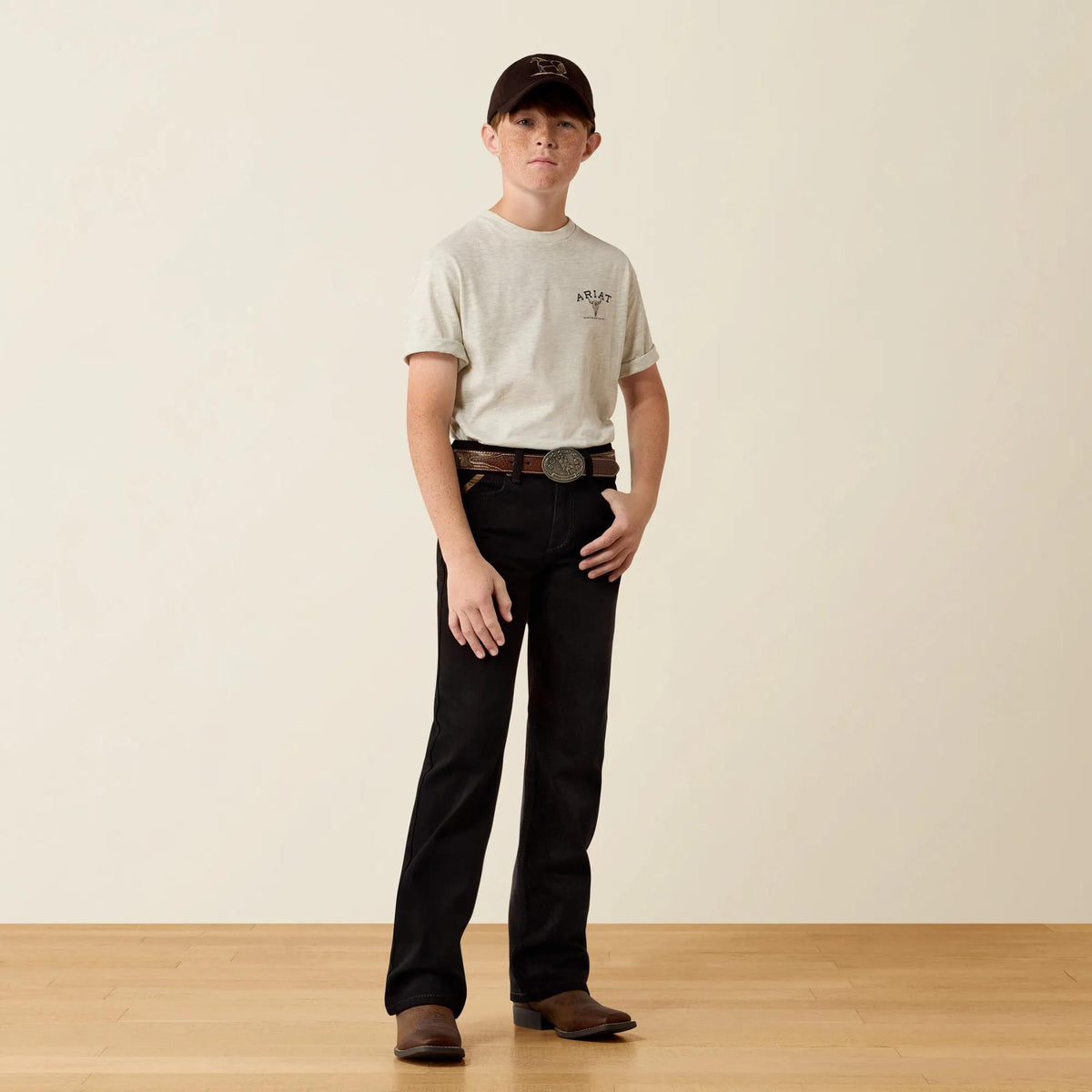 Ariat Youth B4 Relaxed Hansen boot cut jeans in black, full-length view on model