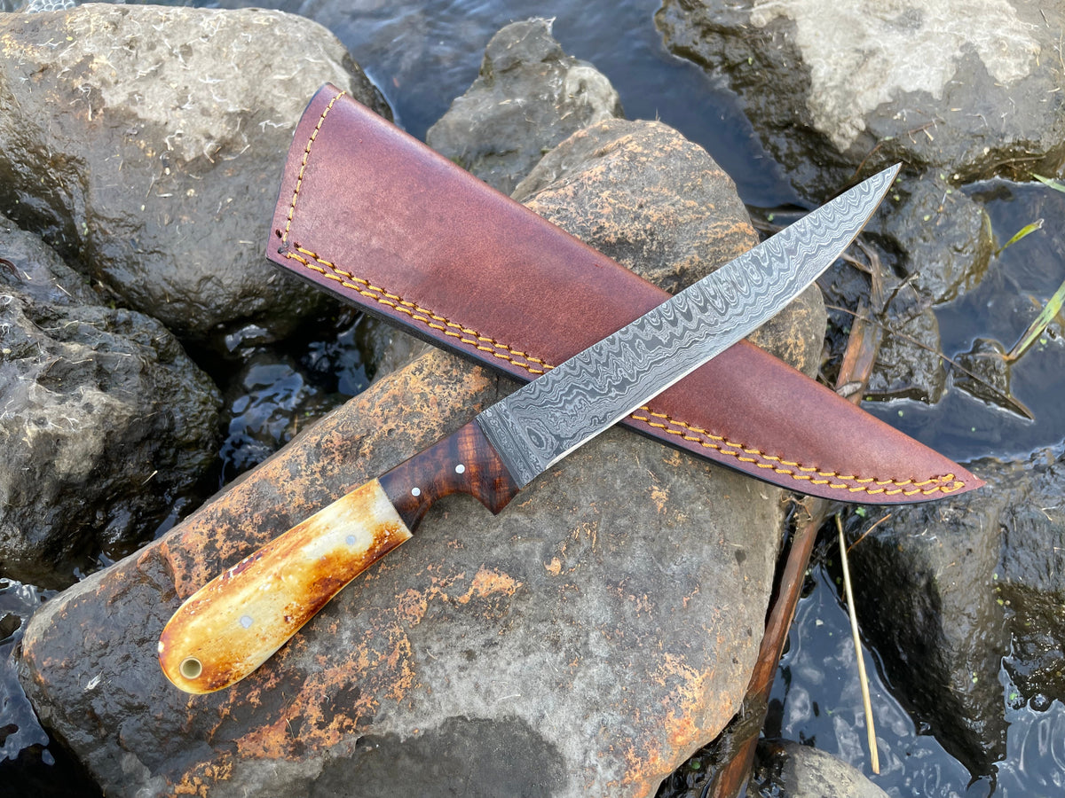 Titan International K boning and flaying knife with high carbon ladder Damascus blade, detailed for precise butchering tasks.