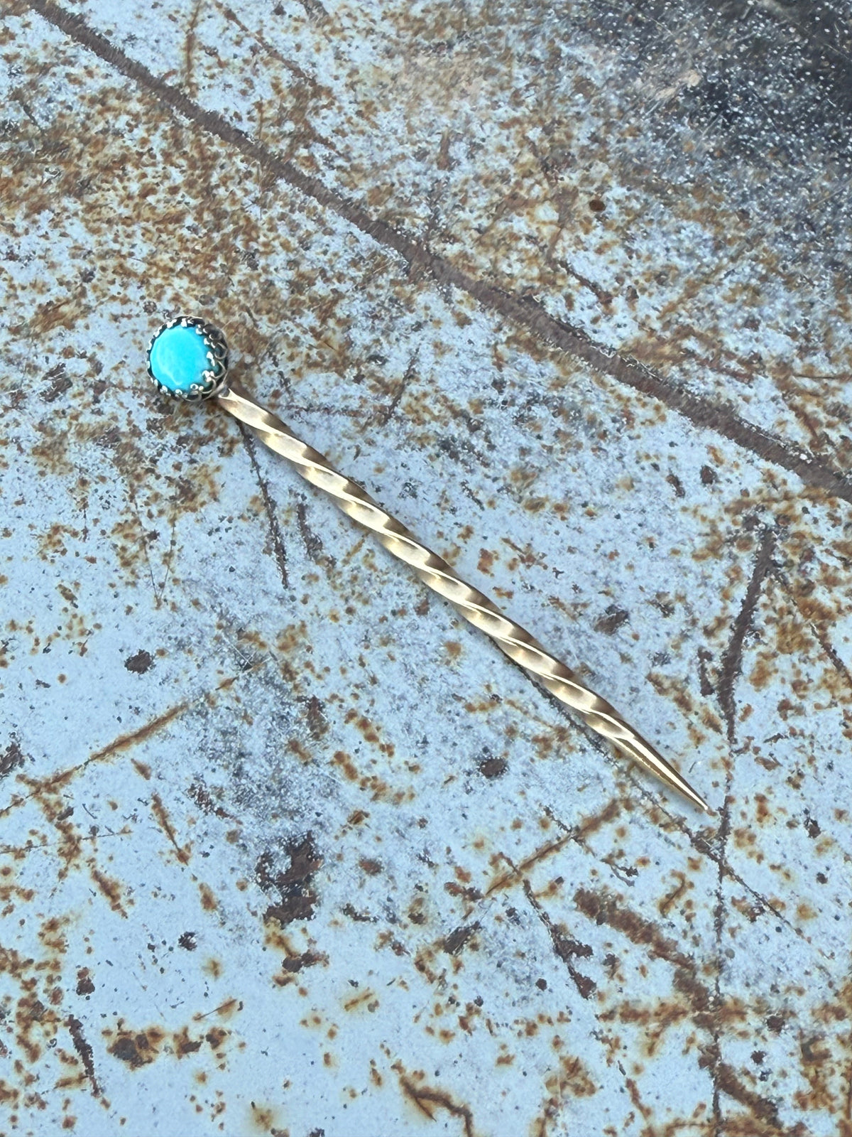 Boles Silver cowboy toothpick with silver brass and turquoise stone accents, featuring a Western-inspired design.
