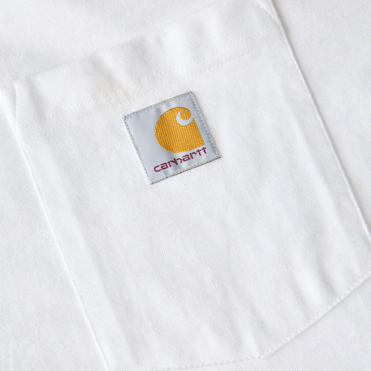 White Carhartt Men's Iconic K87 Pocket T-Shirt with chest pocket and classic fit, made from soft cotton fabric.