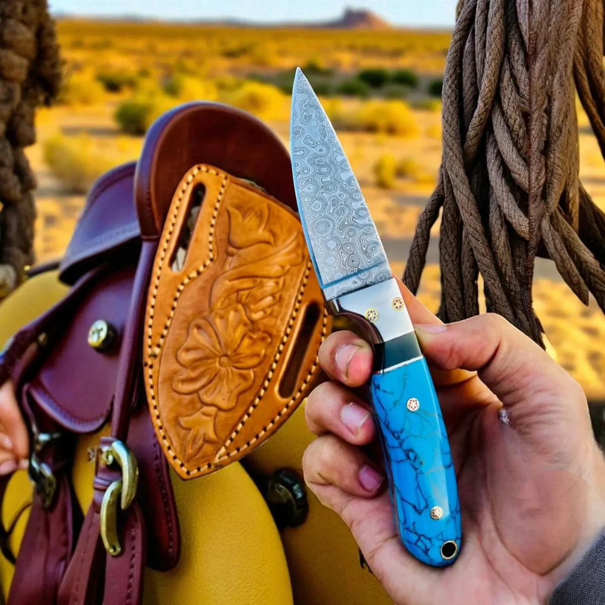 Malika Knives cowboy hunting knife with Damascus steel blade and marble handle, showcasing a simple, durable design.