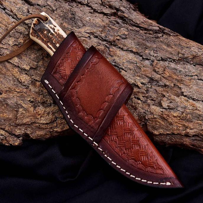 Malika Knives cowboy knife with D2 steel blade, 5mm thick, antler and turquoise handle, showcasing a simple design.
