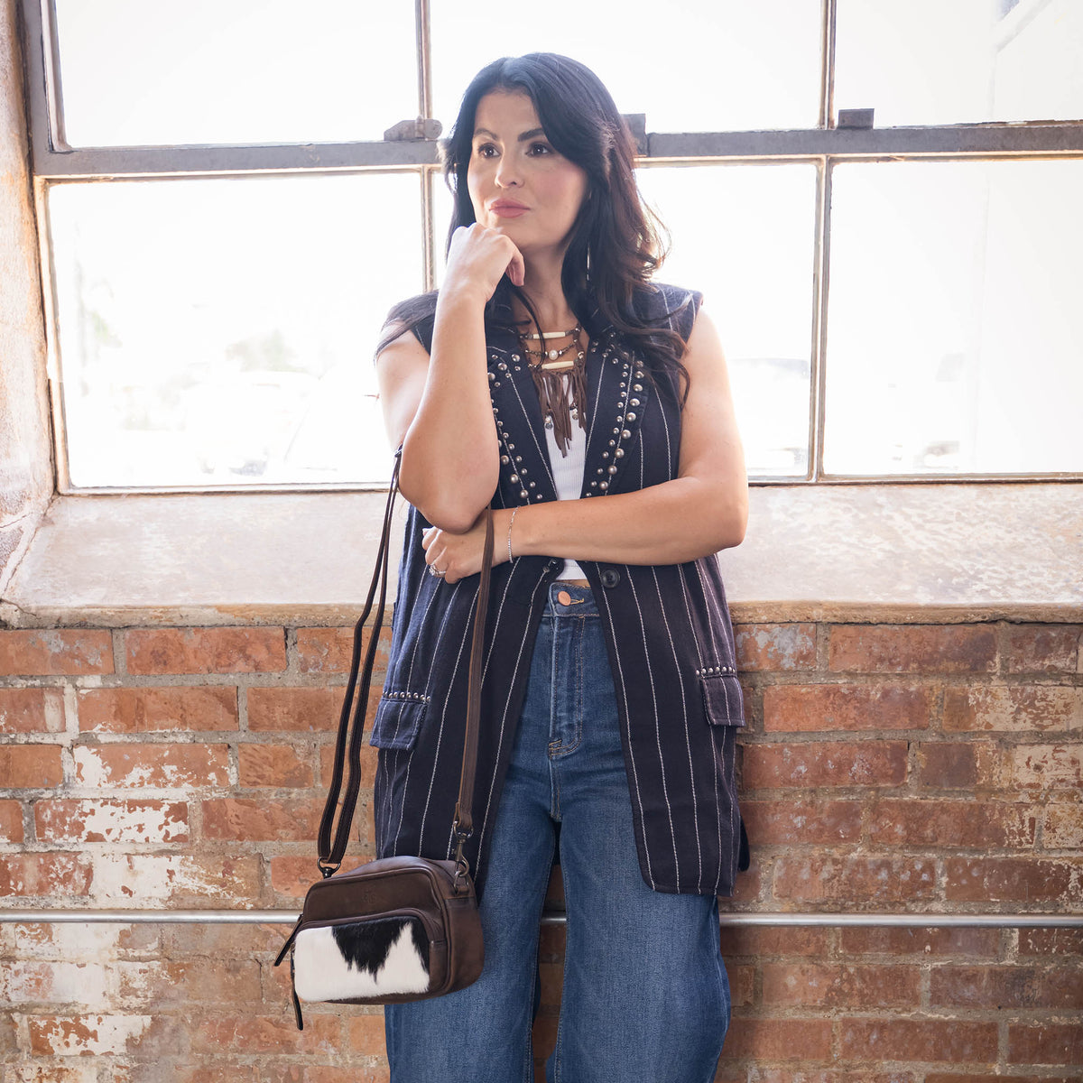 STS Ranchwear cowhide Jess crossbody bag with adjustable strap and rustic leather finish, ideal for casual and outdoor style.